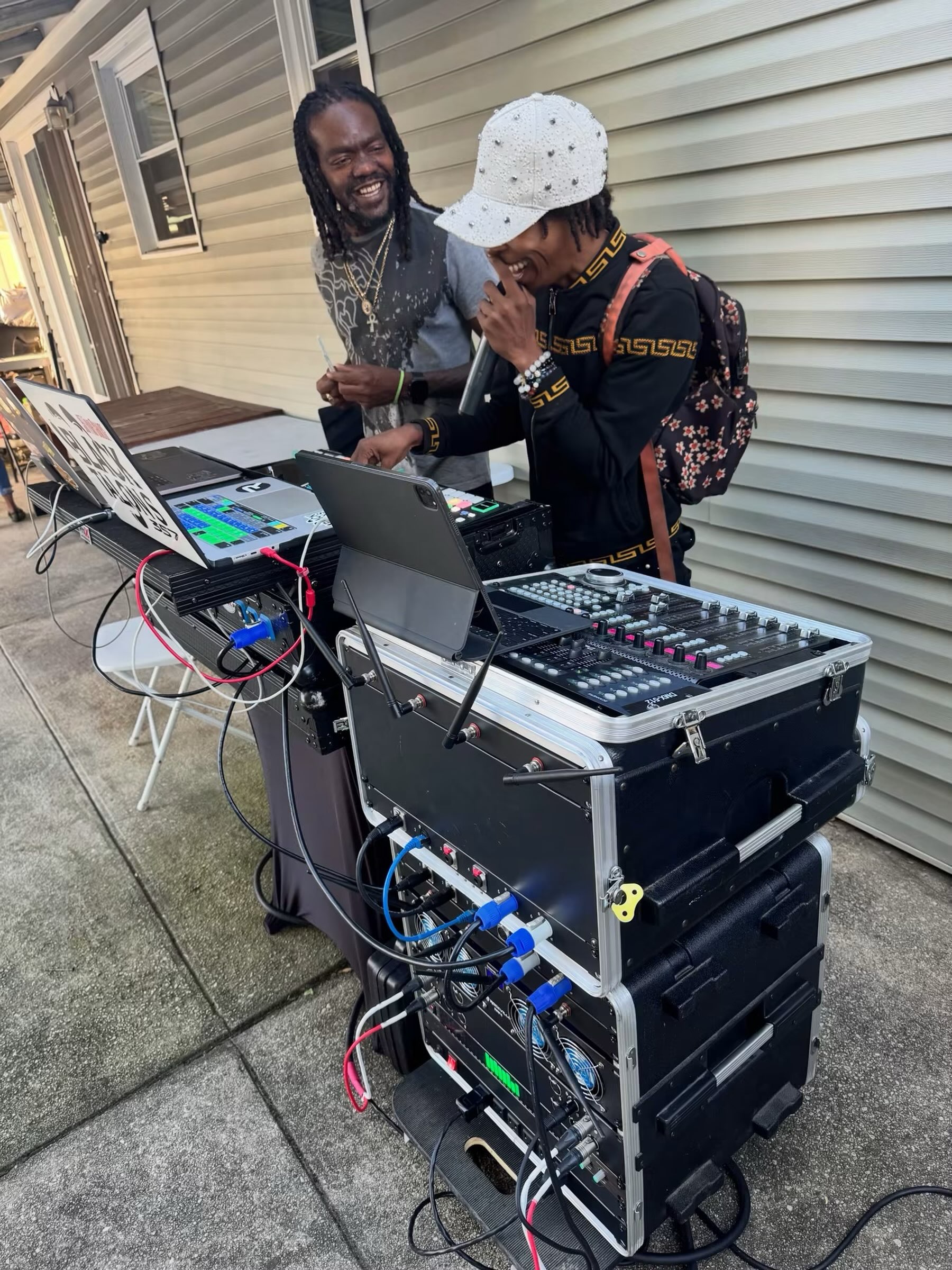 Shorts Temper on the mic behind the outdoor DJ setup